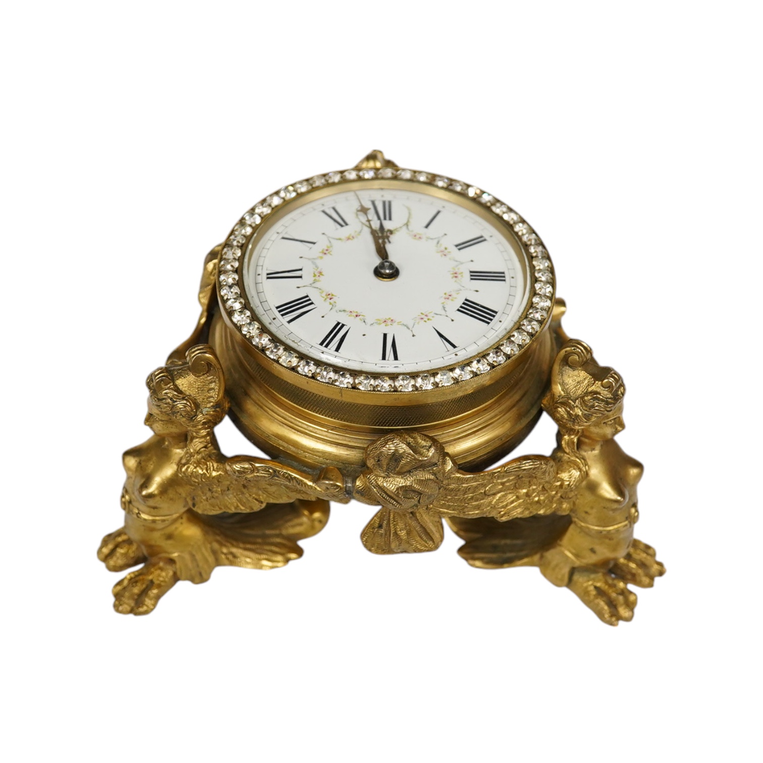 A 19th century French ormolu table timepiece decorated with paste jewelling edged dial and three classical figures, widest point 15cm. Condition - good, not been checked as working